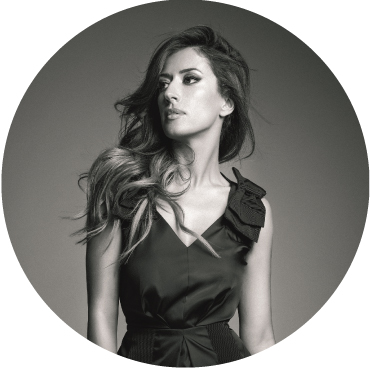 Black and white photo of Ana Moura wearing a black top, looking off in the distance
