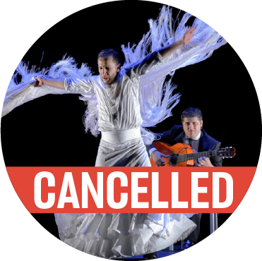 Dancing in a white skirt and top with fringe hanging down from Manuel Linan's outstretched arms with a poppy colored "cancelled" banner over the image