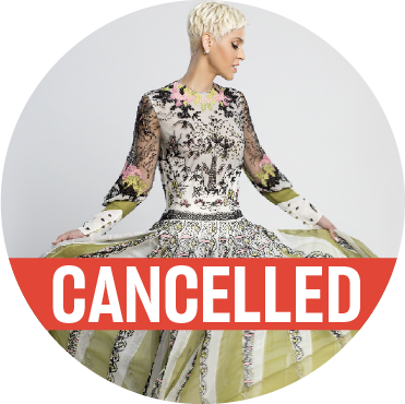Mariza standing with her arms holding up a beautifully detailed green, silver, and black dress while looking off to the side with a "cancelled" banner over the image