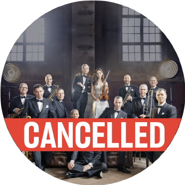 Max Raabe & Palast Orchestra formal group photo in warehouse in front of brick wall and windows with a poppy colored "cancelled" banner over the image