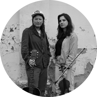 Black & White photo of Nora Brown (left) standing by Stephanie Coleman (right)