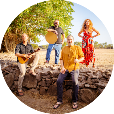 Zafarn stands with their instruments against a stone wall