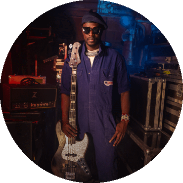Alune Wade poses with a bass guitar
