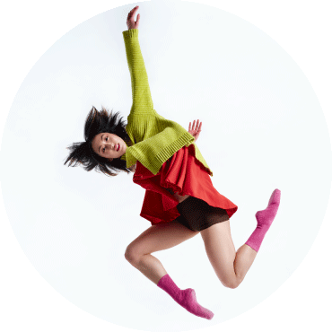 BalletX dancer poses against a white backdrop