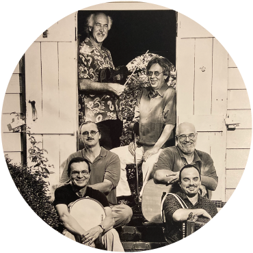 The group poses together on a doorstep in black and white