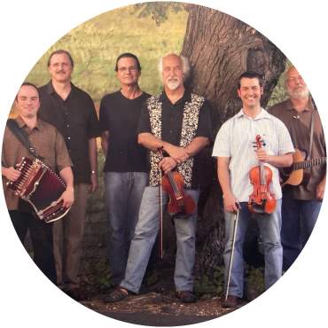 The group poses together against a green and brown backdrop with their instruments