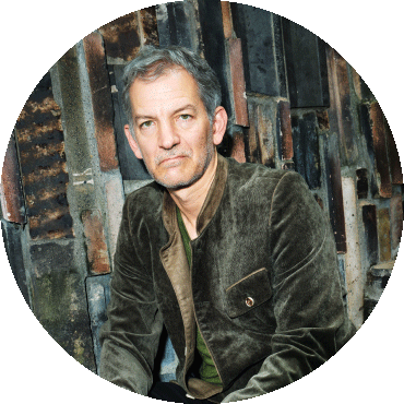 Brad Mehldau sits and looks at the camera