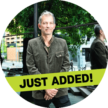 Brad Mehldau poses outside with a 'just added' banner on top of the image
