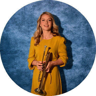 Bria Skonberg smiles and holds her trumpet