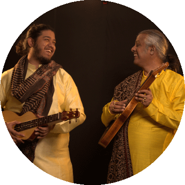 Debashish Bhattacharya and Suryadipta Bhattacharya smile at each other