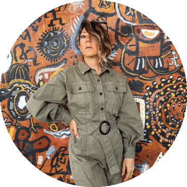 Gretchen Parlato stands in front of a mural