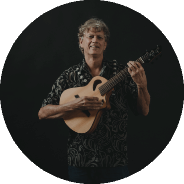 Jim "Kimo" West poses while holding a guitar