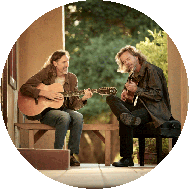 Jack West and James Nash sit and play their guitars