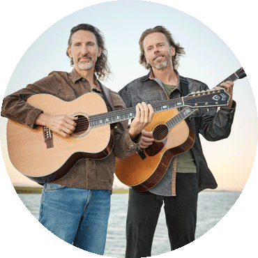 Jack West and James Nash stand and hold their guitars
