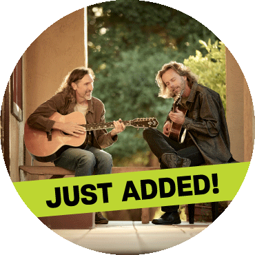 Jack West and James Nash play their guitars with a 'just added' banner on top of the image