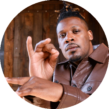 Keyon Harrold imitates holding a trumpet with his hands