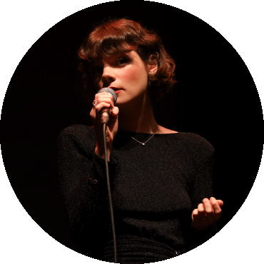 Laura Anglade sings into a mic