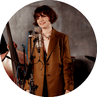 Laura Anglade smiles in front of a microphone