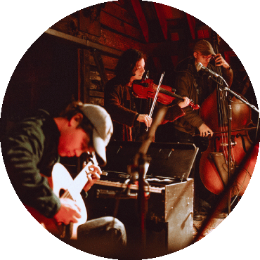 Members of Magic Tuber Stringband play instruments together