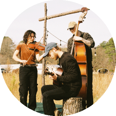 Members of Magic Tuber Stringband play instruments together