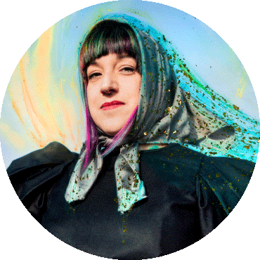 Maria Mazzotta looks straight with a scarf wrapped around her head