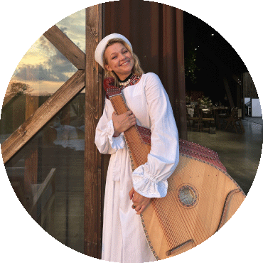 Maryna Krut smiles and holds a bandura