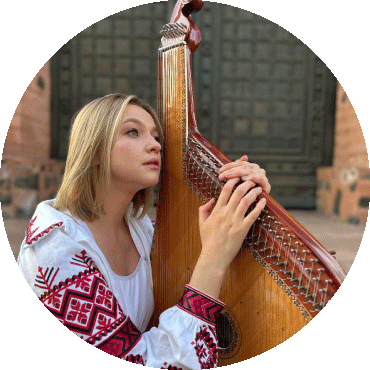 Maryna Krut looks to the side and holds a bandura