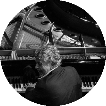 Monty Alexander plays the piano while smiling