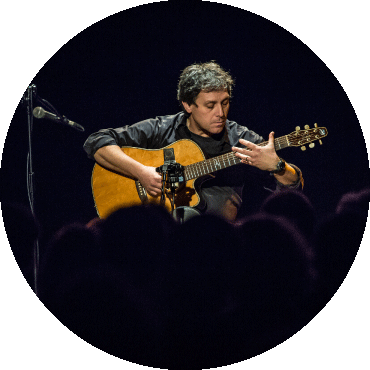 Peppino D'Agostino playing the guitar on stage