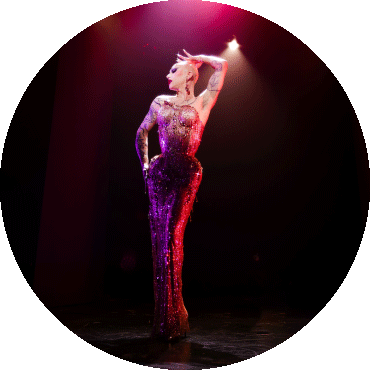 Sasha Velour poses with an arm on their head and looking to the side