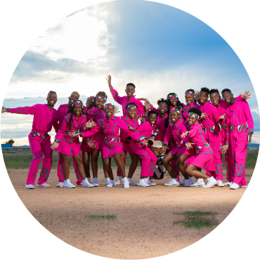 Ndlovu Youth Choir wears pink clothing and poses together outside
