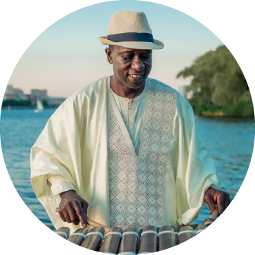 Balla Kouyate plays balafon against an ocean backdrop