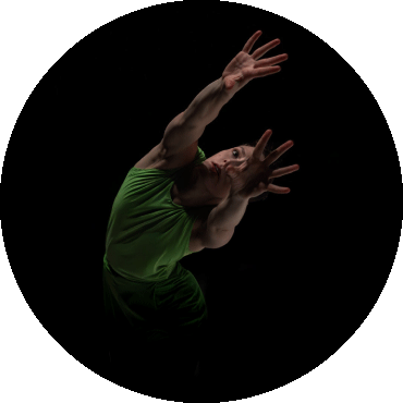 Dancer reaches forward with both arms