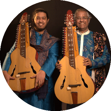 Debashish Bhattacharya and Suryadipta Bhattacharya smile and hold their instruments