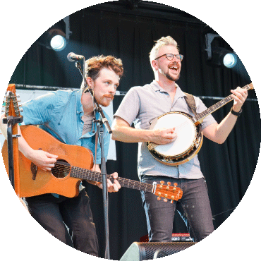 Howley performs on stage with their instruments