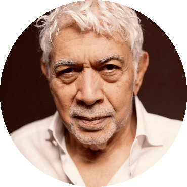 Monty Alexander looks straight at the camera wearing a white shirt