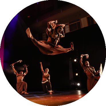 Dancer jumps while performing on stage