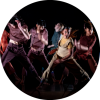 Five dances perform on a dimly lit stage.