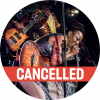Natu Camara has dark skin with black and red dreadlocks. She wears a black long leather tank top, gray jeans, small stud earrings, and a spiral bracelet on her upper arm. She has a guitar on and bends over and sings into a microphone. There is a red "Cancelled" banner along the bottom.