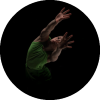 Dancer reaches forward with both arms