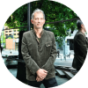 Brad Mehldau stands outside and poses