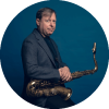 Chris Potter holds a saxophone