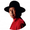 Djavan wears a black hat with a large rim and wears a red shirt. He stands sideways but his head is facing forward