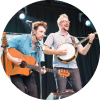 Howley performs on stage with their instruments