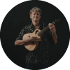 Jim "Kimo" West poses while holding a guitar