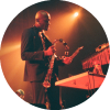 Isaiah Collier holds a tambourine while performing on stage