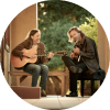 Jack West and James Nash sit and play their guitars