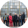 Members of Kotoko Brass pose together in front of a building