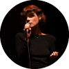 Laura Anglade sings into a mic 