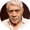 Monty Alexander looks straight at the camera wearing a white shirt